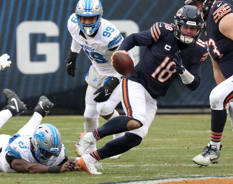 Chicago Bears quarterback Caleb Williams scrambles away from the Detroit Lions pressure during their game Sunday, Dec. 22, 2024, at Soldier Field in Chicago.