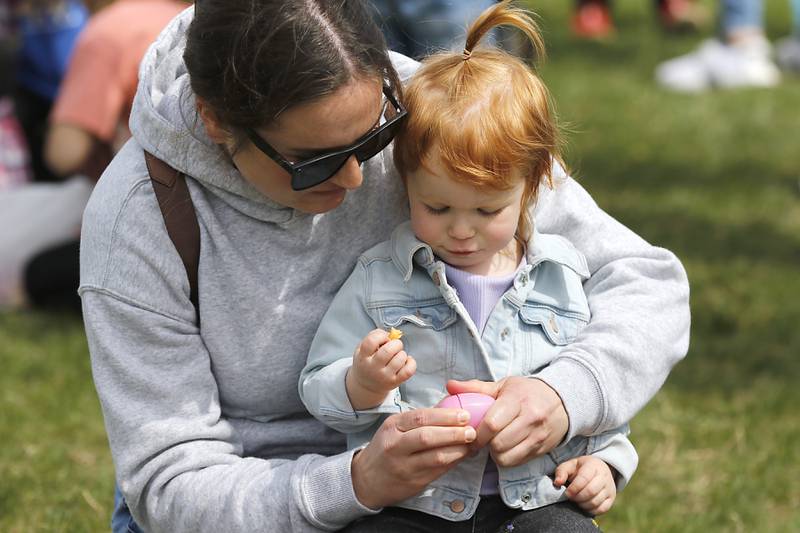 Courtney March helps her daughter Rivalry open Easter egg on Saturday, April 19, 2025, during the Johnsburg Easter Egg Hunt at Sunnyside Memorial Park, in Johnsburg. Children hunted for 6,000 candy-filled eggs in three hunts divided by age group.