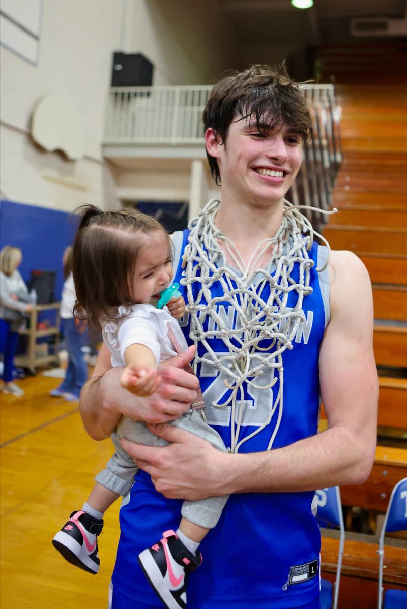 Princeton senior Noah LaPorte tries to charm a young fan following Friday's regional championship victory over Seneca.