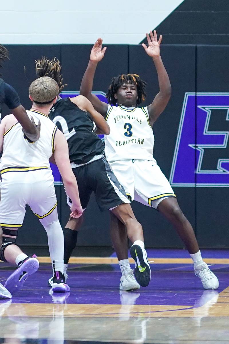 Yorkville Christian's Jayden Riley (3) takes a charge from Kaneland's Isaiah Gipson (2) during a championship final basketball game in the 61st annual Plano Christmas Classic at Plano High School on Saturday, January 1, 2017.