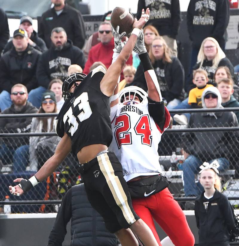 Forreston's Mickey Probst (24) battles Lena-Winslow's Tyree Davis (33) for the ball on a pass play by the Cardinals during 1A playoff action in Lena on Saturday, Nov. 1, 2025.