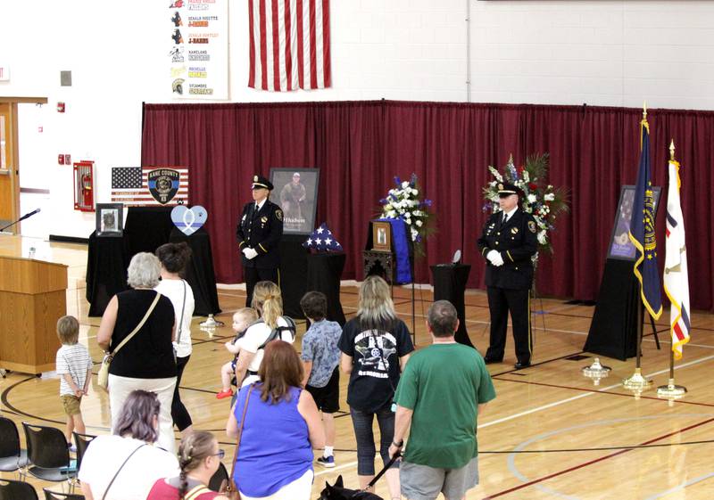 Members of the public file past the remains of Kane County Sheriff K9 Hudson during a funeral in honor of the Dutch shepherd, who lost his life in the line of duty last month, on Thursday, June 1, 2023 at Kaneland Harter Middle School in Sugar Grove.