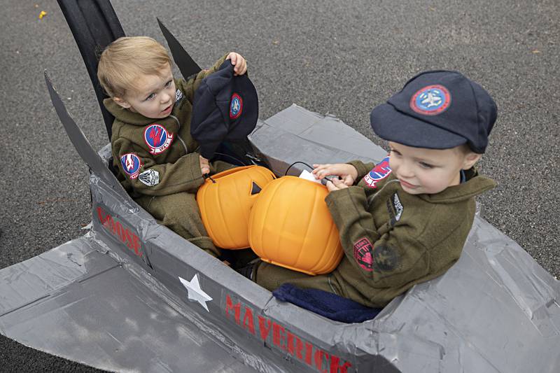Top Gun jet fighter pilots Walker (left), 20 months, and Mason Knudtson, 3, soar at cruising speed through the Sterling Park District’s trunk-or-treat Wednesday, Oct. 25, 2023.