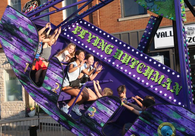 Kids ride the Flying Dutchman carninal ride during Spring Valley Summerfest on Thursday, June 19, 2025 downtown Spring Valley. The festival features a carnival, live entertainment, food vendors and fireworks on Saturday at dusk.