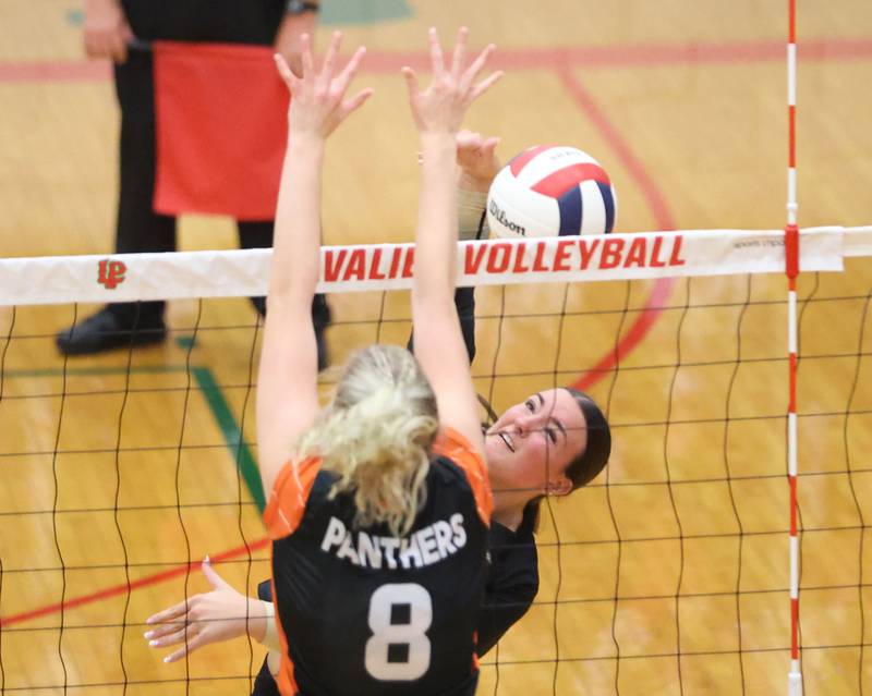 Sycamore's Sophia Lichthardt sends a spike past Washington's Haley Ashley  during the Class 3A Sectional semifinal game on Tuesday, Nov. 4, 2025 in Sellett Gymnasium at L-P High School.