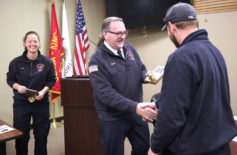 Genoa-Kingston Fire Department Chief Bruce Kozlowski presents plaques Thursday, Nov. 2, 2023, at the department to the firefighters involved in the delivery of Eleanor Lee Altepeter-Knotts. A crew from the department delivered the baby in the ambulance along the side of the road Sept. 29 when they realized they weren’t going to make it to the hospital in time.