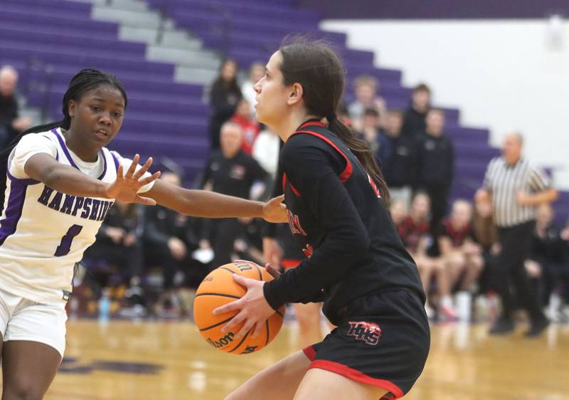 Huntley’s Alyssa Borzych, right, looks for an option as Hampshire’s J’mrya Mcroy defends in varsity girls basketball on Wednesday, Feb. 11, 2026, at Hampshire High School in Hampshire.