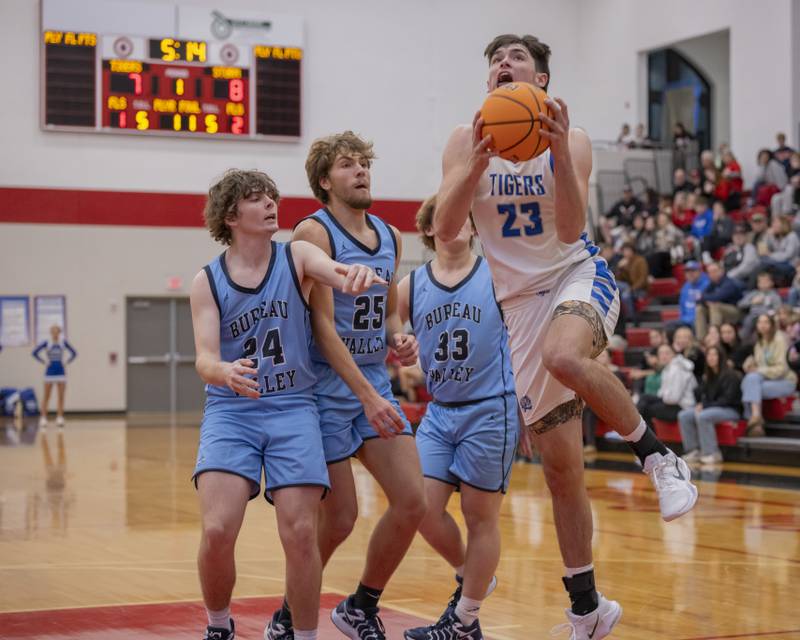 Noah Laporte of Princeton attempts a layup through numerous Bureau Valley defenders during the Colmone Classic on December 7, 2024 at Hall High School.