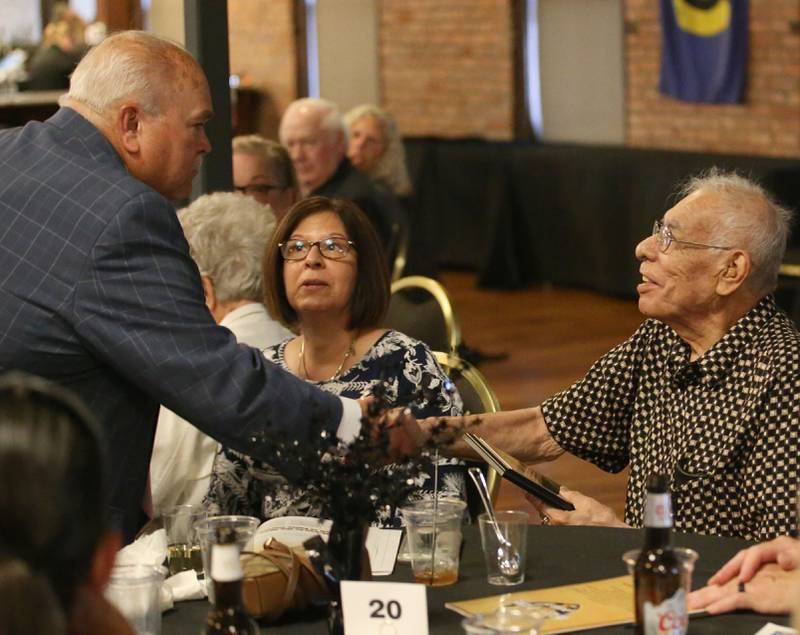 Rick Sipovic hands Frank Montez, a member of the 1951-1952 DePue boys basketball team listens to the presentation of the legacy award honoring the team during the Shaw Media Illinois Valley Sports Hall of Fame on Thursday, June 8, 2023 at the Auditorium Ballroom in La Salle.