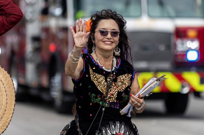 Marge Franchini, of Fiestas Patrias, waves during the City of Joliet Fiestas Patrias Mexican Independence Day Parade on Sept. 13, 2025.