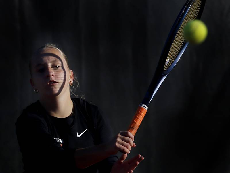 Crystal Lake Central’s Evie Johnson returns the ball Thursday, Oct. 23, 2025, during the first day of the IHSA State Girls Tennis Tournament at Schaumburg High School.