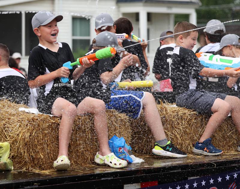 Riders on a float spray the crowd as they head down Main Street Friday, July 4, 2025, during the Fourth of July parade in downtown Kirkland.