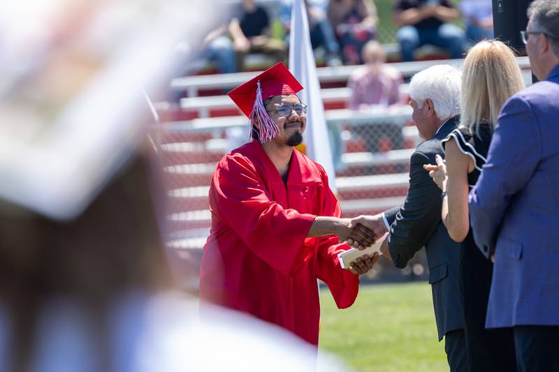 Joel Arevalo shakes administrators hands after graduating on Sunday, May 18, 2025 at Hall High School in Spring Valley.