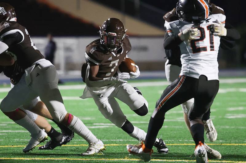 Joliet Catholic’s HJ Grigsby finds a hole on a run against Leo on Friday, Oct. 6, 2023 in Joliet.