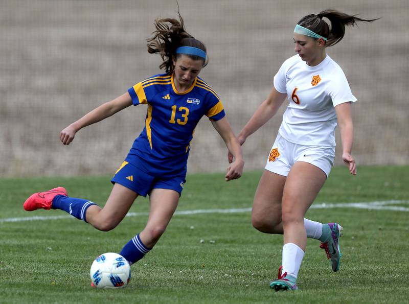 Johnsburg's Dorothy Ruth kicks the ball as Richmond-Burton's Charlotte Gentry closes in during the Kishwaukee River Conference Girls Soccer Tournament Championship match on Wednesday, May 6, 2026, at Johnsburg High School.