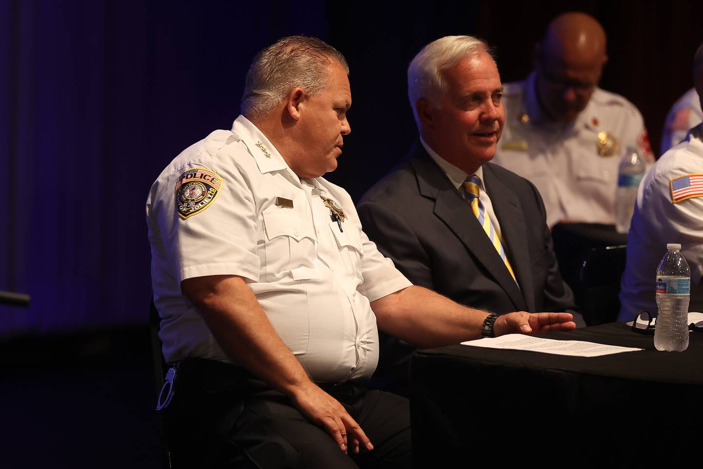 Joliet Police Chief Bill Evans speaks with Mayor Terry D’Arcy before the start of the Public Safety Open Forum at the Billie Limacher Bicentennial Park Theatre on Wednesday June 26, 2024 in Joliet.