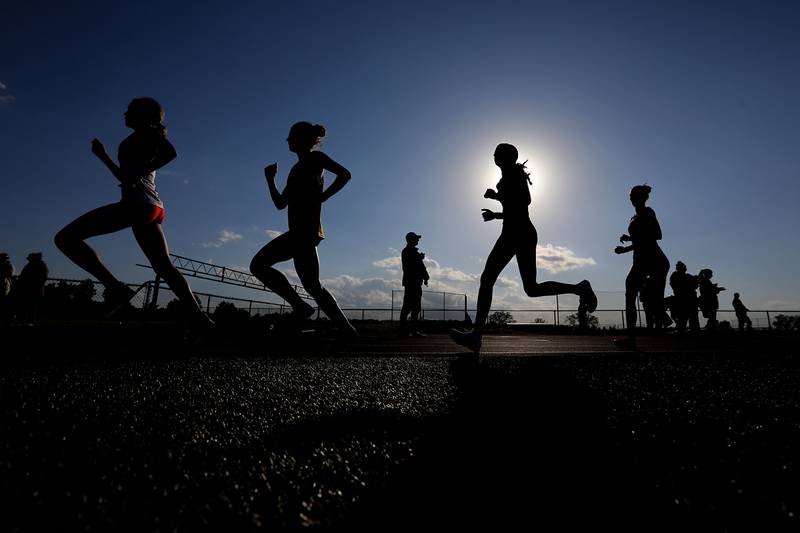 Runners compete in the 3,200 meter run on Thursday, May 7, 2026, during the Fox Valley Conference Girls Track and Field Meet at Huntley High School.