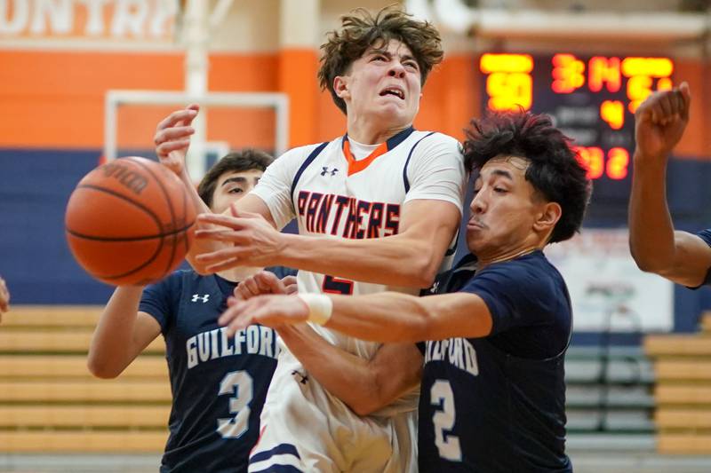 Oswego’s Mariano Velasco (5) is fouled by Rockford Guilford Connor Doyle (2) Rockford Guilford during a hoops for healing basketball tournament game at Oswego on Monday, Nov. 25, 2024.