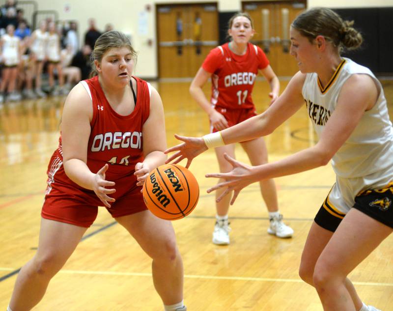 Oregon's Noelle Girton (44) and Riverdale's Molly Skahill (10) reach for a loose ball at the 2A Erie-Prophetstown Regional on Thursday, Feb. 20, 2025.