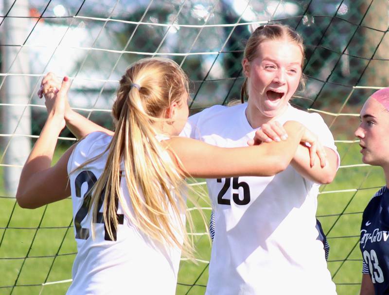 Prairie Ridge’s Anna Mertel, right, celebrates her goal with teammate Adella Pollack, left,  in varsity girls soccer at Cary-Grove High School in Cary on Tuesday, April 29, 2025.