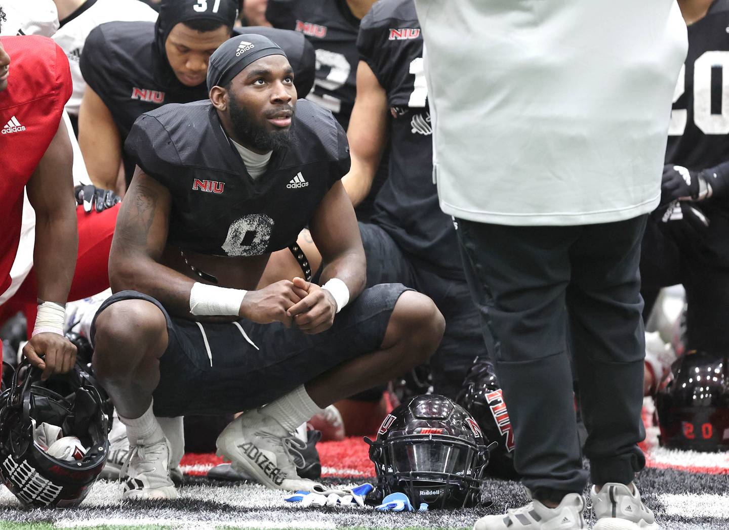 Northern Illinois University linebacker Daveren Rayner listens to head coach Thomas Hammock talk at the end of the session Wednesday, March 30, 2022, during spring practice in the Chessick Practice Center at NIU in DeKalb.