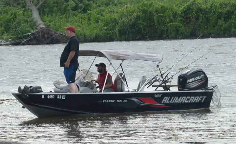 A fisherman stands on the bow of a boat as it nears the public boat ramp at the Glenn Miller Marina near Erie on Saturday, June 22, 2024.