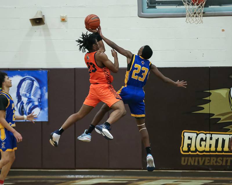 Romeoville's DJ Porter Jr (23) puts up a shot against the defense of Joliet Central's Danny Thompson (23) in the WJOL Tournament Championship game. Nov 25, 2023.