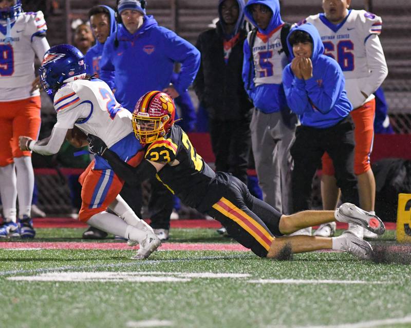 Batavia's Andrew Cultta (23) brings down Hoffman Estates's ball carrier Landon Ford (28) during the first round of playoffs on Friday Oct. 31, 2025, held at Batavia High School.