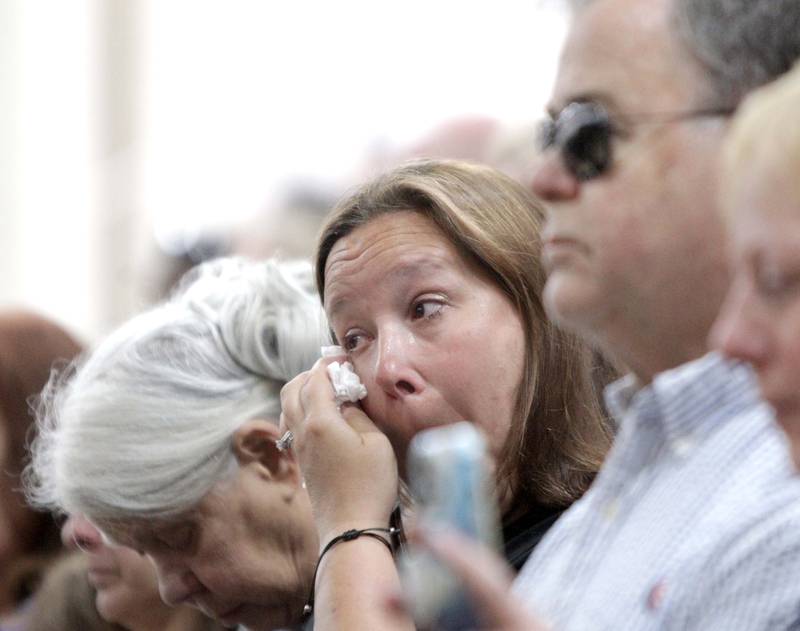 Cathy Racila of Huntley wipes a tear during a funeral in honor of Kane County Sheriff K9 Hudson, who lost his life in the line of duty last month, on Thursday, June 1, 2023 at Kaneland Harter Middle School in Sugar Grove.