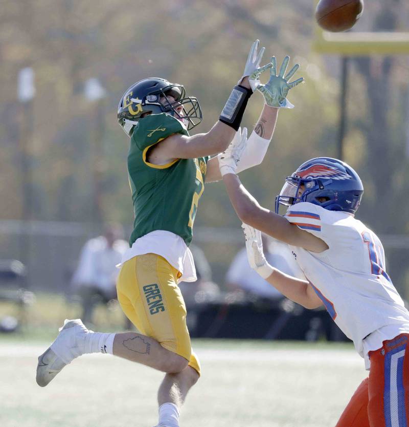 Elk Grove’s Garrett Ewen, 2, looks in a pass over Hoffman Estates’ Brett Phillips, 10, Saturday October 29, 2022 in Elk Grove Village.