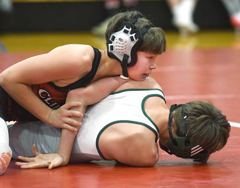 Amboy's Keegan Altherr (top) wrestles West Carroll's Nate Moore in their 106 pound match at Oregon High School on Tuesday, Nov. 25, 2025.