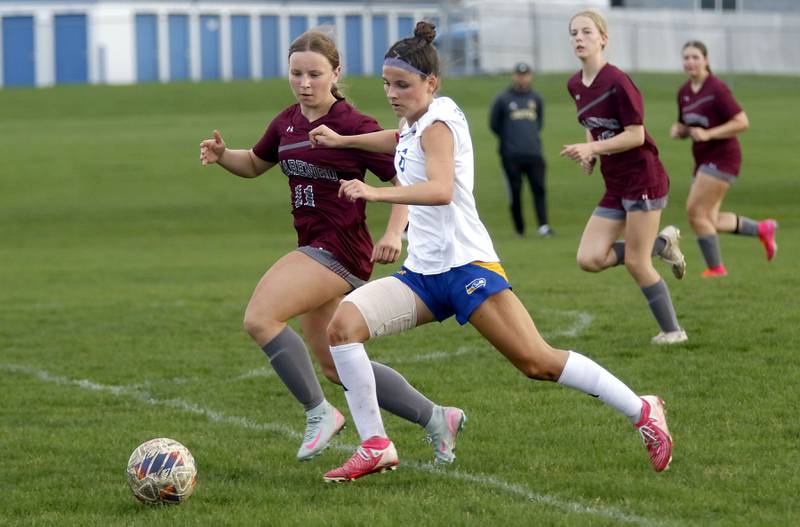 Johnsburg’s Liz Smith pushes the ball down the field against Marengo's Mackenzie Westwood during a Kishwaukee River Conference soccer match on Wednesday, April 15, 2026, at Marengo High School.