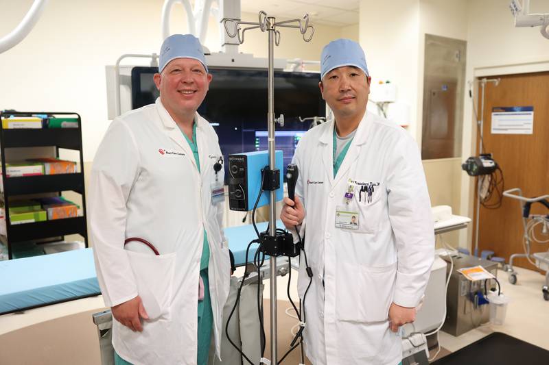 Dr. Christopher Bane, left, and Dr. Hong Jun Yun poses with the Shockwave IVL machine at Silver Cross Hospital. Shockwave IVL is relatively new technology that uses shock waves to break up kidney stones and other calculuses while leaving soft tissue undisturbed. Monday, April 25, 2022, in New Lenox.