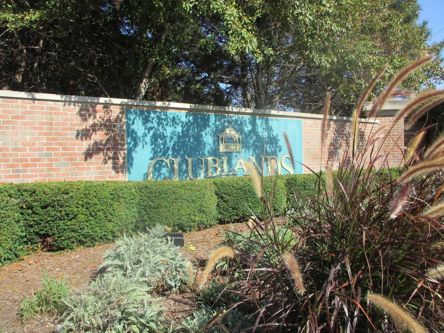 A monument facing Theodore Street marks the entrance to the Clublands, a Joliet subdivision that was the scene of a domestic murder-suicide Monday morning. Sept. 29, 2025