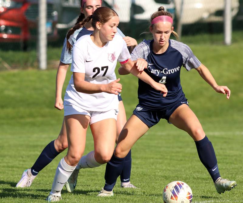Cary-Grove’s Ava Santucci, right, keeps pace with Prairie Ridge’s Ava Gertz in varsity girls soccer at Cary-Grove High School in Cary on Tuesday, April 29, 2025.