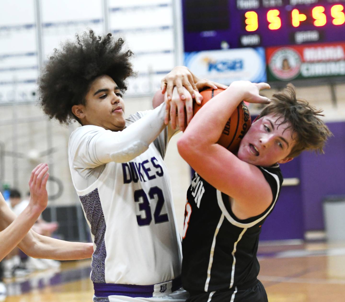 Dixon's Darius Harrington (32) and Byron's Caden Considine (33) battle for a rebound during Big Northern Conference action on Tuesday, Jan. 31 at Lancaster Gym in Dixon.