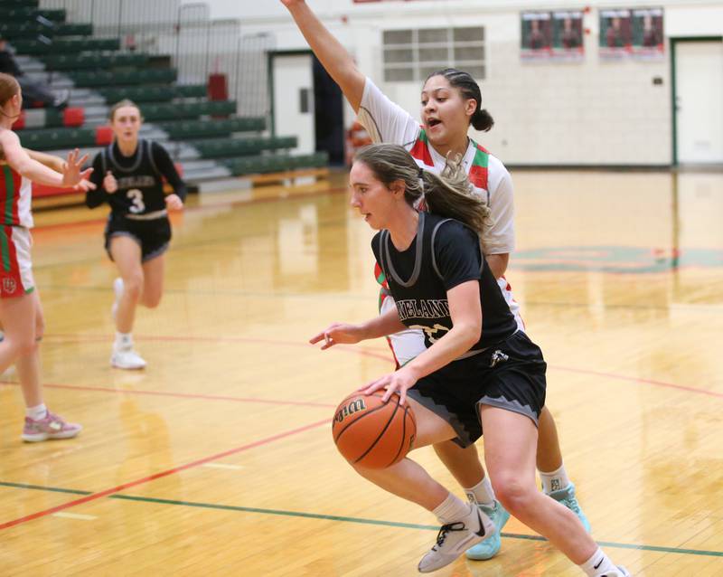 Kaneland's Kyra Lilly dribbles around L-P's Jasmone Garman on Friday, Dec. 8, 2023 in Sellett Gymnasium at L-P High School.