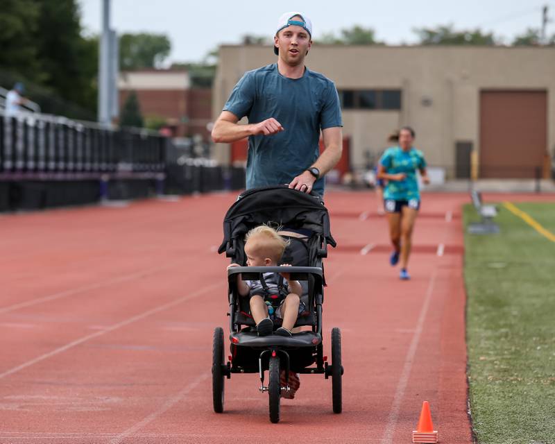 Cody Boender and son finish the mile run's first heat at the community festival and running fundraiser for mental health awareness and suicide prevention in honor of Ben Silver.  July 23, 2022.