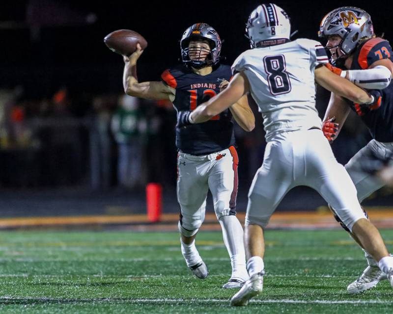 Minooka's Nathan Maul (12) passes for a touchdown during football game between Plainfield North at Minooka.   Oct 6, 2023.