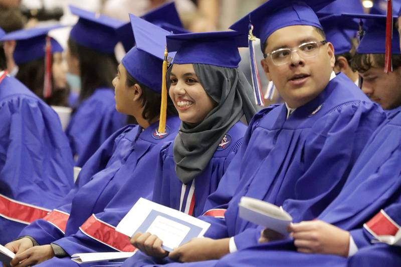 Graduates look for family and friends in the gym during the Glenbard South High School graduation ceremony Friday May 20, 2022 in Glen Ellyn.