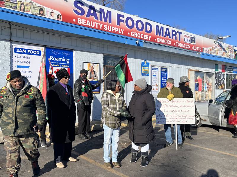 Attendees at a rally held on Saturday, Jan. 4, 2025, outside Sam Food Mart, 121 Richards St., Joliet.
