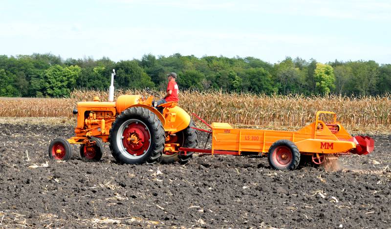 An antique Minneapolis Moline tractor and manure spreader work on a field during the Bos Historical Farm Old Fashioned Fall Harvest south of Erie on Springhill Road on Saturday, Sept. 21, 2024.