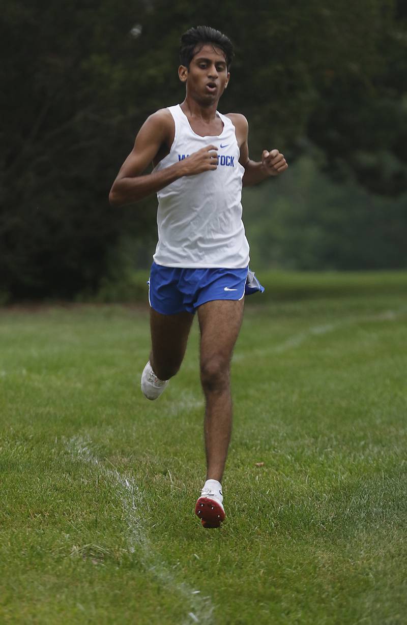 Woodstock’s Ishan Patel leads the boys race of the McHenry County Cross Country Meet Saturday, August 27, 2022, at Emricson Park in Woodstock.