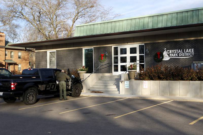 A Crystal Lake Park District police officer gets items out of the police vehicle outside  the Crystal Lake Park District office on Wednesday, Dec. 20, 2023, in Crystal Lake. The park board is considering disbanding its police department that was established in 1924 and is the only park district police force in McHenry County.
