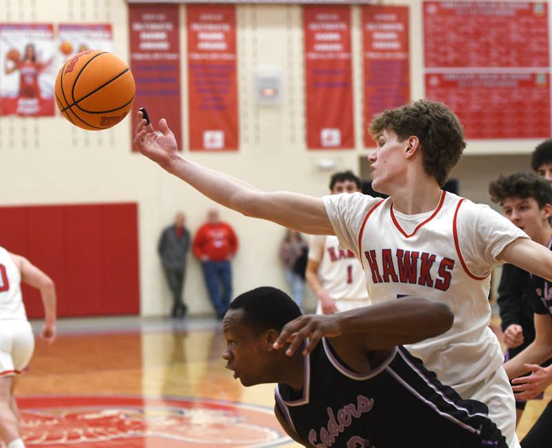 Oregon's Tucker O'Brien (5) reaches over Rockford Lutheran's Richard Anderson during a Big Northern Conference game on Friday, Feb. 6, 2026 at the Blackhawk Center in Oregon.