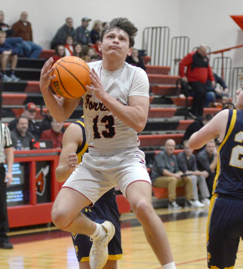Forreston's Kendall Erdmann (13) drives to the basket on Tuesday, Jan. 7, 2024 at Forreston High School. Erdmann led all scorers with 32 points.