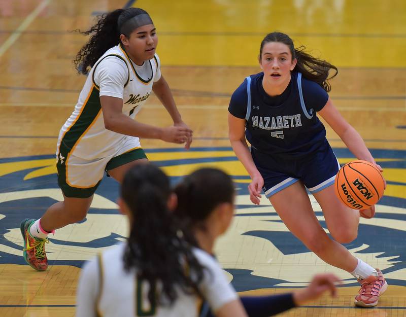 Nazareth’s Sophia Towne drives past Waubonsie Valley’s Arianna Garcia-Evans (left) during the Class 4A Lyons Supersectional game on March 2, 2026 at Lyons Township High School in LaGrange.