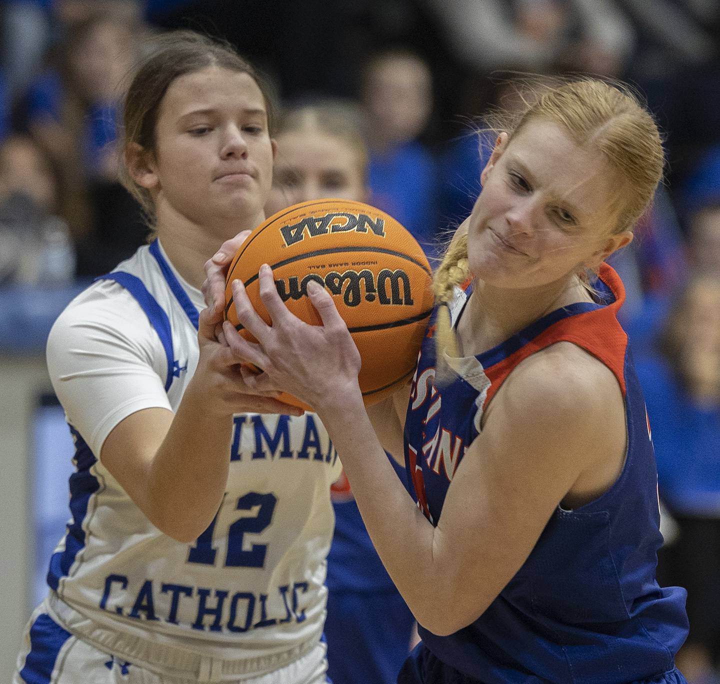 Newman’s Lucy Oetting and Eastland’s Violet Diehl grabble for a loose ball Tuesday, Jan. 7, 2025, at Newman High School.