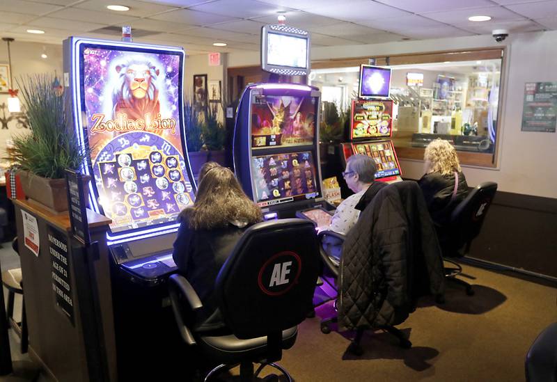 Customers play a game on Tuesday, Nov. 28, 2023, at International House of Wine and Cheese in Richmond. Tom Jiaras, the owner of Hot Shots and the International House of Wine and Cheese, both which have electronic gaming, received a license for gaming in McHenry in October.