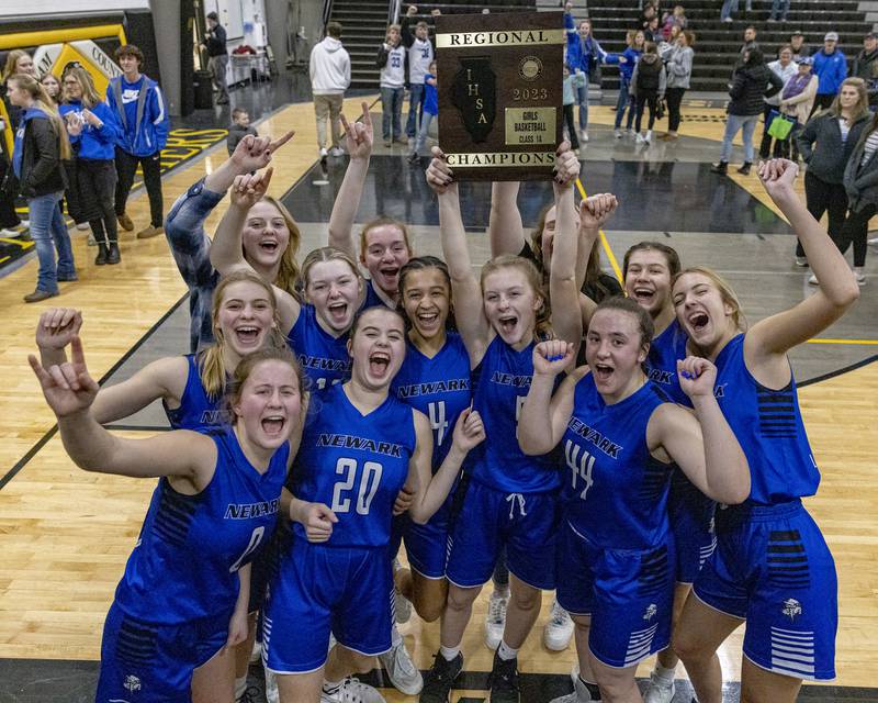 Members of the Newark girls basketball team hoist the Class 1A Regional final plaque after defeating Putnam County on Thursday, Feb. 16, 2023 at Putnam County High School.